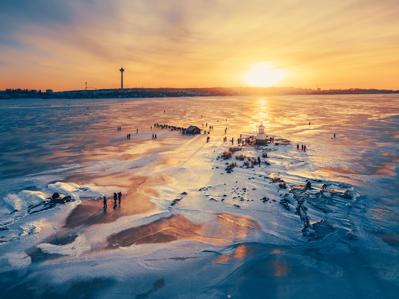 winter in Tampere with people enjoying a walk on the frozen lake